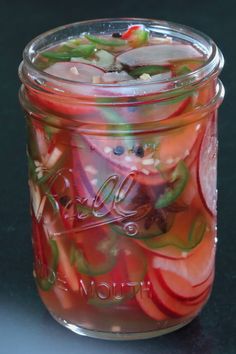 a glass jar filled with lots of fruit and vegetables