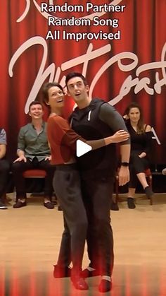 two people are dancing in front of a red curtain with the words random partner written on it