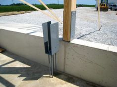 the corner of a building that is being constructed with concrete and steel bars on each side