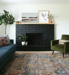 a living room filled with furniture and a fire place in front of a brick fireplace