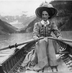 an old photo of a woman in a boat