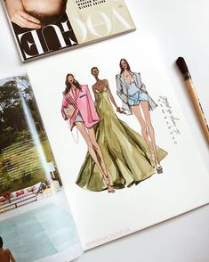 an open magazine with fashion illustrations on it