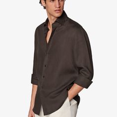 This breezy dark brown button-up shirt is tailored slim with soft collar interlining, a sleek French placket, and a slightly curved hem that makes it perfect for casually wearing untucked. Brown Slim Fit Button-up Shirt, Classic Brown Tops With Button Cuffs, Brown Shirt With Button Closure For Business Casual, Brown Button-up Shirt With Button Cuffs, Formal Brown Tops With Button Cuffs, Formal Brown Top With Button Cuffs, Brown Formal Top With Button Cuffs, Formal Brown Top With Button Closure, Semi-formal Brown Button-up Top