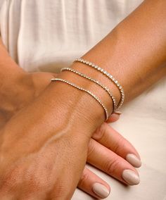 Your favorite Gold Tennis Bracelet, this Diamond Bracelet is dainty and glistens, making it the perfect bracelet(s) for a special occasion as well as everyday wear. We beautifully package every item in a jewelry gift box! Each bracelet is sold individually. * All orders are hand crafted with care from our happy studio in sunny Miami, FL * All items are ethically sourced for durability & perfect finishes * It's not only meant to look beautiful... it's meant to be meaningful * We want you to love Solid Gold Bracelet For Women, Minimalist Cubic Zirconia Bracelets For Party, Dainty Stackable Bracelets For Party, Adjustable Minimalist Diamond Party Bracelet, Adjustable Stackable Cubic Zirconia Diamond Bracelet, Dainty Diamond Jubilee Bracelet For Party, Minimalist Cubic Zirconia Tennis Bracelet With Adjustable Chain, Adjustable Dainty Diamond Bangle Bracelet, Dainty Adjustable Diamond Bangle Bracelet