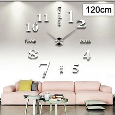 a living room with a pink couch and large clock on the wall above it's face