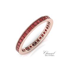 a rose gold ring with red diamonds