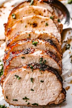 sliced pork loin sitting on top of a cutting board