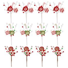 six candy lollipops are arranged in the shape of flowers and hearts on sticks