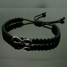 Fashionable And Durable Hand-Made Black String Bracelet With An Infinity For Wrist Sizes 6 To 9 Inches, With An Easy To Use Zip Like Function To Fit Your Wrist, You'll Have It On As Soon As You Get It. Made From High Quality Black String, It Will Be Sure To Last. Each Bracelet Is Carefully Handcrafted And Given Proper Time To Ensure Quality. Fast Shipping Metal Bracelet With Black Band, Metal Jewelry With Black Band For Gift, Metal Bracelet With Black Band As Gift, Black Metal Braided Bracelets As Gift, Black Metal Braided Bracelet For Gift, Black Metal Braided Bracelet Gift, Black Adjustable Friendship Bracelets, Casual Stainless Steel Braided Bracelet As Gift, Trendy Black Band Bracelet