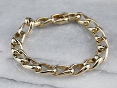 This chunky chain bracelet has an impressive weight to it! The uniquely designed links interlock in a stylish way, and have an exceptionally bright polish. A strong box clasp and safety clip ensure security when worn. Metal: 14K Yellow Gold Width: 8.4 mm Length: 7.5 Inches Marks: "14K" Stamped on the clasp Bracelet Layering, Gold Curb Chain, Curb Chain Bracelet, Cameo Ring, Hand Ring, Box Clasp, Layered Bracelets, Wardrobe Basics, Curb Chain