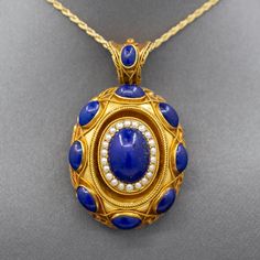 Exquisite Antique Etruscan Revival Lapis and Pearl Locket Pendant in 18k Yellow Gold The contrast in color of this locket is exquisite, and it is impeccably made.  The locket features cabochons of natural lapis lazuli, with the center cab surrounded in a frame of seed pearls.  This is a picture locket with a window on the back which can be opened and a photo inserted.  It features a really wide bail so that the piece can be worn over large chains or silk ribbon.  The locket is crafted in 18k (x Lapis And Pearl, Pearl Locket, Victorian Locket, Picture Locket, Antique Jewelry Necklace, Seed Pearl, Locket Necklace, Silk Ribbon, Gold Stars