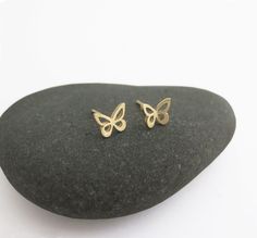 "14k gold butterfly stud earrings. Pretty and dainty earrings, handmade of solid 14k gold. I cut each butterfly with a jeweler's saw, from a solid gold sheet, file it, and solder a 14k gold post to the back of each one. I give the small butterflies a shiny mirror-like finish. You can choose between a few options: A cute mismatched pair - one butterfly flat and the other is with raised wings. A pair of flat earrings. Or pair with raised wings. Butterflies symbolize hope, transformation, rebirth a Gold Minimalist Earrings With Butterfly Charm, Minimalist Gold Earrings With Butterfly Charm, 14k Gold Butterfly Charm Earrings, 14k Gold Butterfly Earrings With Butterfly Charm, 14k Gold Butterfly Earrings With Charm, 14k Gold Butterfly Earrings For Gift, Minimalist Butterfly Earrings For Everyday Wear, Minimalist Butterfly Charm Earrings, Minimalist Butterfly Charm Earrings For Gift