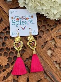 Infuse your style with a dash of Mexican charm with our hand-painted heart earrings. Each pair is meticulously crafted by skilled artisans, capturing the essence of Mexico's rich culture and artistic heritage.  Every piece is completely unique because of the detailed process that goes into creating it. The black lacquer is created by mixing in layers of dirt with a grease from the Cochinilla bug. The flowers are painted on with our finger tips using ground up natural pigments and linseed oil. To Multicolor Tassel Earrings For Gifts, Unique Multicolor Tassel Earrings For Gift, Heart-shaped Pierced Earrings For Festivals, Traditional Heart-shaped Jewelry For Festive Occasions, Traditional Tassel Earrings As Gift, Traditional Heart Earrings As Gift, Traditional Heart Earrings For Pierced Ears As Gift, Nickel-free Heart Earrings For Festivals, Nickel Free Heart Earrings For Festivals