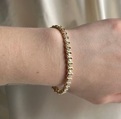 Sparkly gold synthetic stone bracelet with an open box clasp.  Pre-loved item. Stamped 14KT gold.  Size (approx.): 6.5" long, 0.3cm wide.  Weight: 11.090g **FREE shipping within Canada and USA** If you have any questions or concerns, please do not hesitate to contact us. We will be more than happy to help you and answer any inquiries.  We invite you to check out our shop for more fabulous items! Elegant Hinged Gold Bracelet As Gift, Elegant Hinged Gold Bracelet Gift, Elegant Hinged Gold Bracelet For Gift, Elegant Hinged Bracelets As Gift, Elegant Hinged Bracelet As A Gift, Elegant Hinged Bracelet For Gift, Gold Hinged Bracelet As A Gift, Gold Hinged Bracelets As A Gift, Gold Bracelet Perfect As A Gift