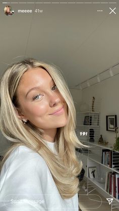 a woman with blonde hair is smiling at the camera