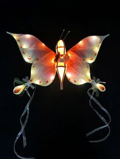 an orange butterfly with lights on its wings