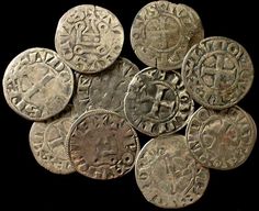 a pile of old silver coins sitting on top of each other