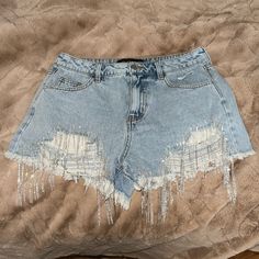 Denim Shorts With Silver Sparkly Fringe At Front Distressed Casual Denim Bottoms For Party, Casual Denim Party Bottoms, Summer Party Cutoff Bottoms, Casual Cutoff Bottoms For Party, Party Cutoff Denim Shorts, Casual Silver Denim Bottoms, Blue Denim Bottoms For Party, Short Denim Jeans For Party, Denim Party Shorts