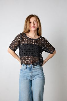 This cute and on trend black crochet top will be your new favorite top. We love the open knit design. It features a wide circle neckline with a black bandeau underneath and short sleeves. Pair with your favorite denim jeans or dress it up with a mini skirt. *Materials: Self- 100% Polyester. Lining- 95% Rayon, 5% Spandex Size & Fit: Materials: Self - 100% polyester, Lining - 95% Rayon, 5% Spandex Fit: This top is true to size. Jessi is wearing a size small.Length: The length hits below the natura Chic Short Sleeve Crochet Top With Pointelle Knit, Spring Black Lace Top With Crochet Details, Black Crochet Lace Top For Spring, Spring Pointelle Knit Tops For Night Out, Lace Crochet Top With Short Sleeves, Short Sleeve Open Knit Crochet Top, Lace Crochet Open Knit Top With Short Sleeves, Casual Fitted Crochet Top With Hollow Out Detail, Fitted Casual Crochet Top With Hollow Out