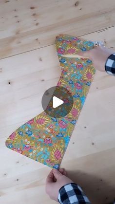 someone is making a tie out of fabric