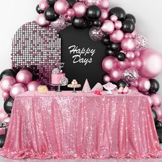 a pink and black birthday party with balloons, cake and desserts on the table