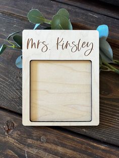 a wooden frame with the words mr and mrs written on it next to some flowers