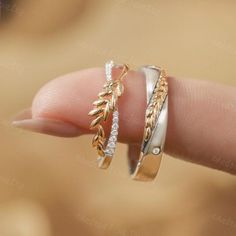 two gold and silver rings on top of each other in the palm of someone's hand