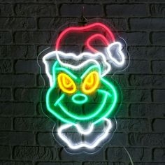 a neon sign with a cat's head in the shape of a santa hat