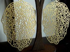 **Orders over $50.00 (shipping not included) receive a free gift Filigree leaf pendants dangle from surgical steel hook, ball and coil ear wires, making this pair of earrings so simple and sooo sophisticated!  The pendants are matte finished gold plated brass and measure 60mm x 39mm.  They are thin and light weight.  Also available in Matte Black https://www.etsy.com/listing/210911300/xylem-lightweight-thin-large-matte-black *Small children should be supervised when handling any small objects as Leaf Skeleton, Filigree Earrings, Earrings Statement, Leaf Pendant, Ear Wires, Gold Leaf, Statement Earrings, Over 50, Handmade Natural