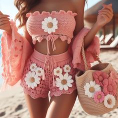 a woman is walking on the beach with her handbag and purse in front of her