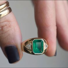 Emeralds are one of nature’s masterpieces—known as “The Jewel of Kings” this gem has been long regarded as a superior stone throughout the ages. Our impressive emerald is framed by just the right amount of sparkle and set in buttery warm gold that glows on wearers hand, making it the perfect statement piece for every body. 3.21 ct Zambian Emerald .60 tcw trillion diamonds 14k yellow gold Band measures 5mm, tapers to 13.4mm face Size 7, sizable Made by Private Label for Good Fortune in Los Angele Luxury Gia Certified Emerald Gemstones, Luxury Oval Emerald Gemstones, Luxury Emerald Gemstones In Yellow Gold, Luxury Emerald Cut Gemstone With 17 Jewels, Luxury Yellow Gold Emerald Gemstones, Luxury Tsavorite Gemstones For Anniversary, Exquisite Emerald Gemstones For Anniversary, Luxury Yellow Gold Gia Certified Gemstones, Classic Formal Emerald Gemstones