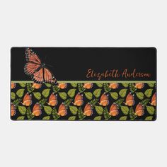 an orange butterfly on black and green leaves with the words, elizabeth ardenn written in red