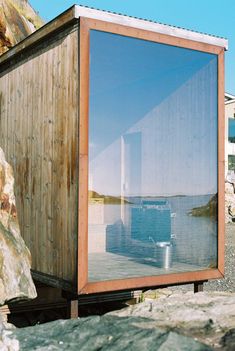 a wooden structure sitting on top of a rocky beach