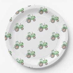 a paper plate with a green tractor pattern on the front and sides, along with white background