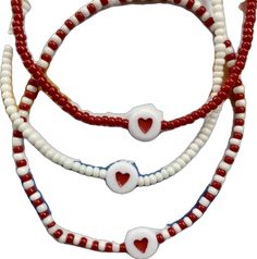 three red, white and blue beaded bracelets with hearts on each strander