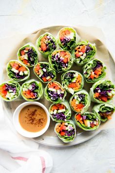 a white plate topped with rolls covered in veggies