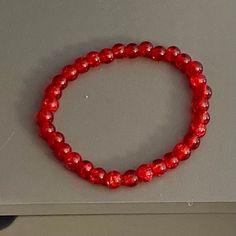 This is a beaded bracelet, made of 6mm acrylic crackle beads in the shade cherry red. The bracelet is stretchy (no clasp) with an approximate circumference of 7 inches.  Thanks for visiting my shop. Please message me if you have any questions! Cherry Red, Wedding Basket, Stretch Bracelet, Bracelet Gift, Stretch Bracelets, Beaded Bracelet, Gift For Her, Beauty Book, Jewelry Bracelets