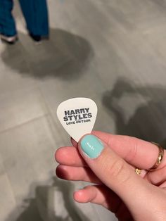 a person holding up a guitar pick with the words happy smiles on it