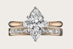 an engagement ring with a pear shaped diamond in the center and side stones on each band