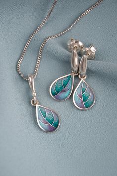 CASUAL BUT CHIC JEWELRY SET IN THE SHAPE OF TINY LEAVES MADE USING EXCELLENT, CENTURIES-OLD CLOISONNE ENAMEL TECHNIQUE. Dimension: Earrings weight ~ 3 gr. (pair) Length - 23mm/0.90'' Width - 9mm/0.35'' Pendant weight ~ 1,5 gr  Length - 25mm/0.98'' Width - 9mm/0.35'' Materials Sterling silver base 925, fine silver wire, hot cloisonné  enamel technique, butterfly backs, 44 cm neck chain (additional) Description The base underneath the enamel layer is engraved which shows deep and transparency of e Cloisonne Enamel Jewelry, Enamel Jewellery, Purple Cute, Small Leaves, Bleu Violet, Earrings And Necklace, Small Leaf, Cloisonne Enamel, Neck Chain