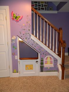 a dog house under the stairs in a child's room with purple walls and white railings