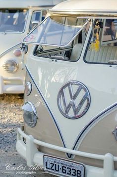 an old vw bus is parked next to other cars