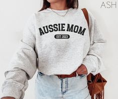 Our personalized Aussie Mom sweatshirt is the perfect gift for all the Australian Shepherd mama's out there! Customize with your dog's birthday year or the year you became a dog mom! **UNISEX SWEATSHIRT- Runs true to size. If you desire an oversized look, selecting 1 or 2 sizes up is recommended. Placing an order- 1. Select sweatshirt SIZE and COLOR fields. Crewneck and Hoodie variations available. 2. Select quantity you want. 3. Click add to cart. Care instructions for washing- Please wash insi Personalized Relaxed Fit Winter Sweatshirt, Casual Personalized Crew Neck Hoodie, Casual Personalized Cotton Hoodie, Casual Crew Neck Hoodie With Personalization, Casual Crew Neck Hoodie With Personalized Details, Casual Hoodie With Name Print, Casual Cotton Hoodie Personalized, Casual Crew Neck Hoodie With Custom Text, Casual Cotton Hoodie With Custom Text