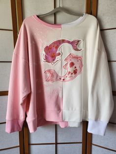 The Koi cape hoodie is now also available as super comfy oversize sweater in White/Light Pink. The Fabric is a very soft, warm Jersey (80% Cotton, 20% Polyester) The inside is fleecy to keep you warm and cozy. Check pictures for measurements. The Koi Carps are hand printed and have a metallic look. Hand wash is recommended, but it is pre washed because the fabric is hand dyed, so it should be fine up to 40o machine wash for the print and to not shrink. Oversized Harajuku Sweatshirt For Fall, White Harajuku Sweater For Fall, Oversized Harajuku Cotton Sweater, Oversized Harajuku Sweatshirt For Spring, Oversized Cotton Harajuku Sweater, White Oversized Hoodie Sweater, Pink Oversized Harajuku Sweatshirt, Oversized Pink Harajuku Sweatshirt, Oversized Pink Harajuku Style Sweatshirt