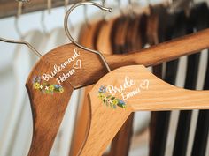 wooden clothes hangers with name tags on them