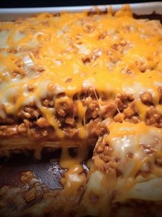 a casserole dish with meat and cheese on it