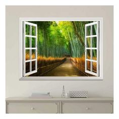 an open window with the view of bamboo trees and a path leading to another room