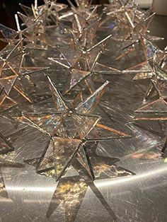 several glass stars sitting on top of a metal table