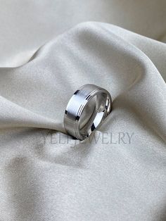 a wedding ring on top of a white cloth