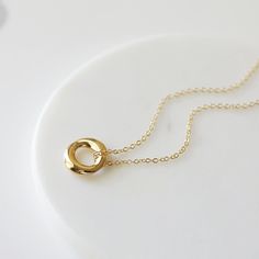 "Beautiful and lovely gold pendant necklace. Made of small gold circle pendant with skinny gold plated brass chain. Soft and warm. Great for gift, everyday or special occasion. Your item will ship in a gift box. Please feel free to contact me if you have any question. ♥ Length 15\" - 20\" ♥ Pendant 5/8\" ♥ Gold plated over brass ♥ See more Rudiana Accessories Rudiana.etsy.com" Gold Circle Minimalist Charm Necklace, Minimalist Circle Charm Gold Necklace, Minimalist Gold Circle Charm Necklace, Simple Gold Charm Necklaces For Everyday, Simple Everyday Gold Charm Necklaces, Everyday Yellow Gold Circle Charm Necklace, Simple Gold Charm Necklaces For Anniversary, Simple Gold Charm Necklace For Anniversary, Gold Circle Charm Necklace For Gift